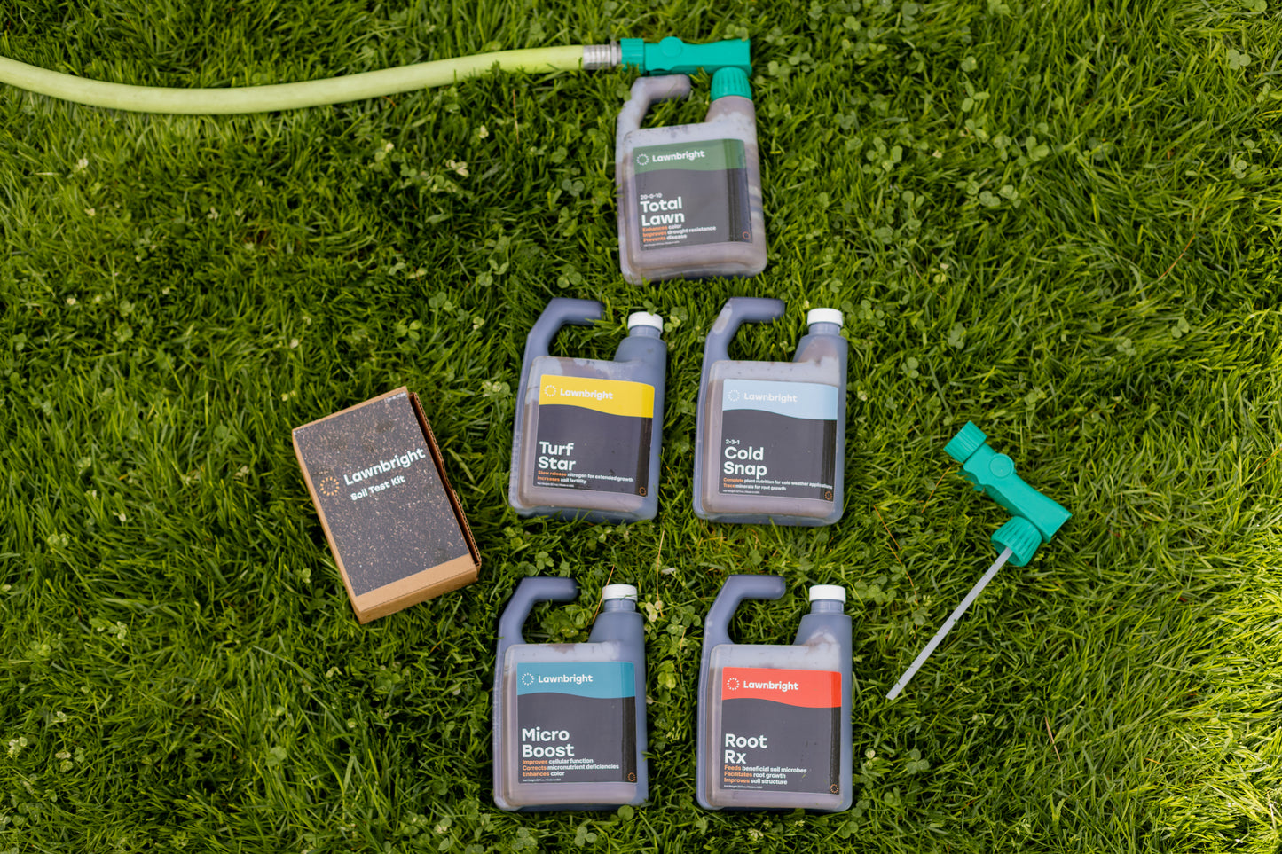 Lawnbright products attached to a hose lying on the grass.